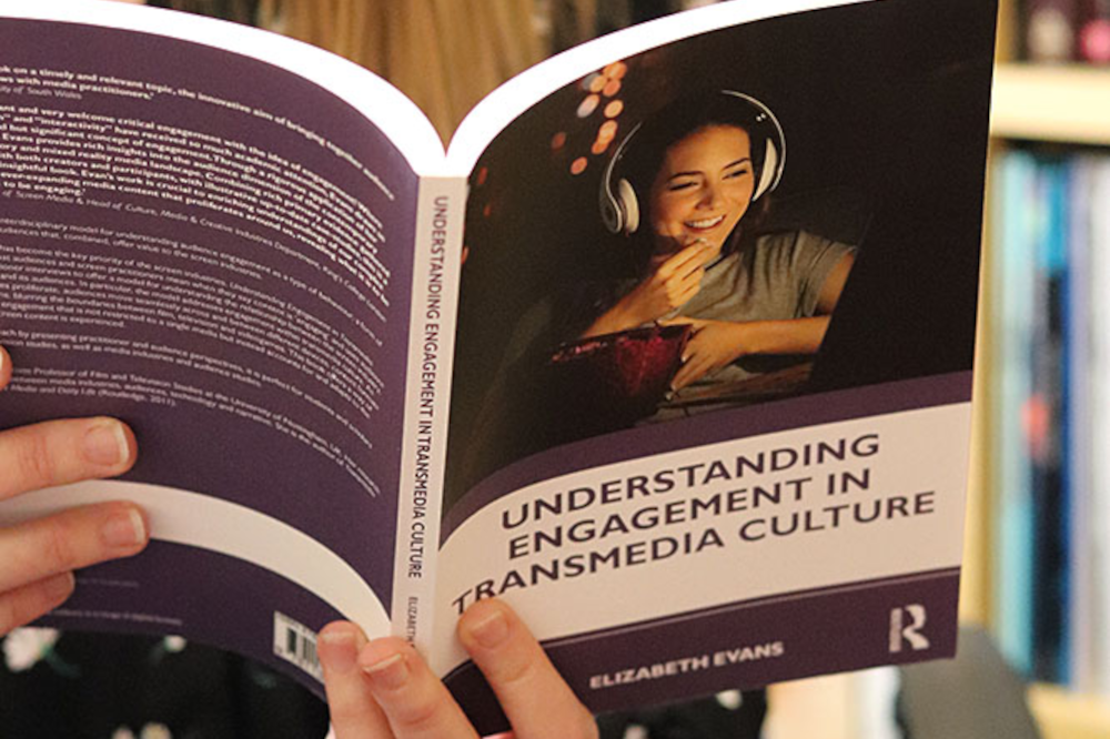 Person holding Understanding Engagement book open