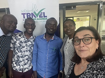 Photo of Job, Dominic, Michael, Pamella and Professor Marina Novelli in front of a wall saying Sustainable Travel and Tourism Agenda.