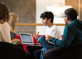 Four undergraduate students sat studying together