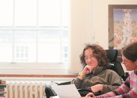 Student and tutor look at document together