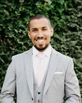 Mohamed Elmaghrbi stood in front of a bush