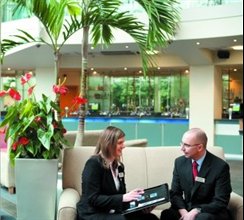 2 EMCC staff sitting in the EMCC foyer