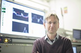 Professor Mark Sumner holding a modem that's used on sensible project houses, Flexelec Laboratory