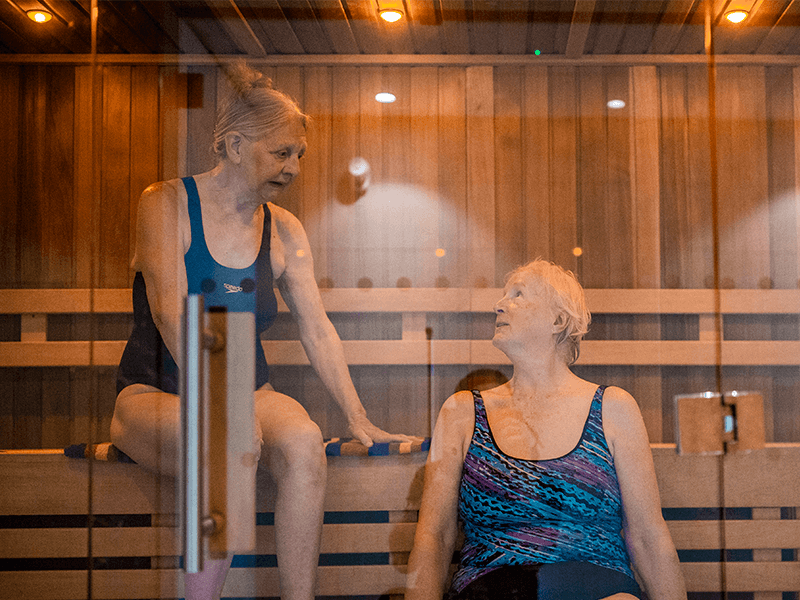 Two females relaxing in the Health and Wellbeing Suite at David Ross Sports Village