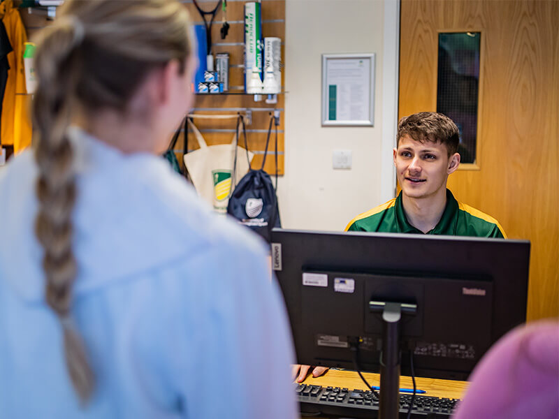 A receptionist at Jubilee Sports Centre talking to a customer