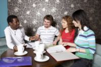 Group of students studying in a cafe