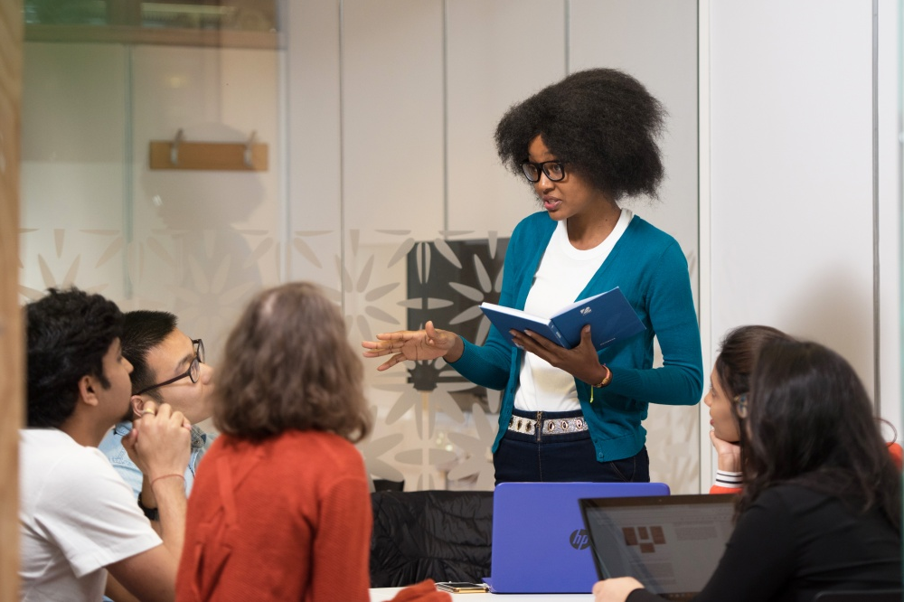 Student explaining to others in small group seminar