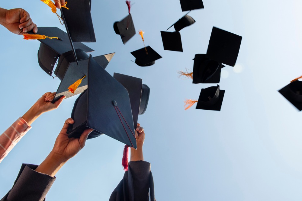 Black hats of graduates floating in the sky