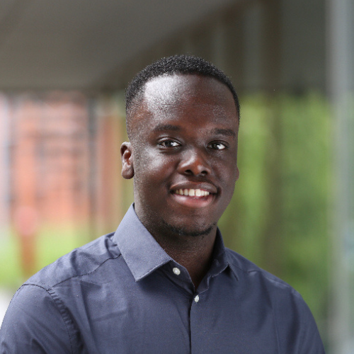 Chris Victor smiling and wearing a dark blue shirt