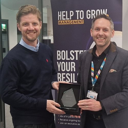 Antony Rhodes receives an award from Executive Education staff member Nick Proverbs for his exceptional engagement on the Help to Grow Management course