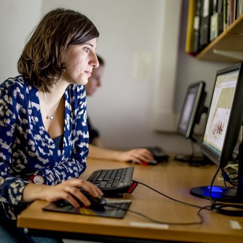 A woman uses a computer in a shared office