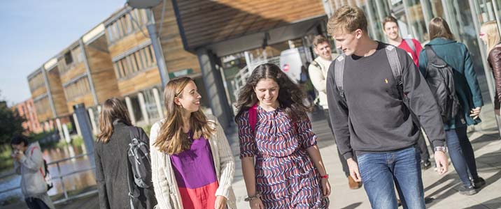 Group of students on Jubilee Campus with the lake and buildings in the background.