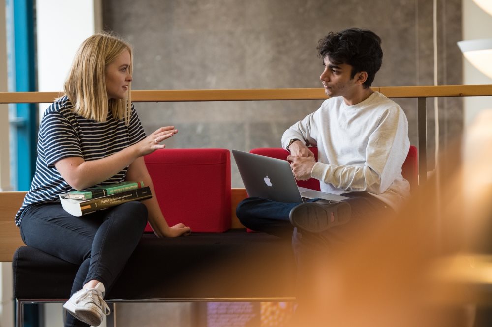 A man and a woman sitting and having a discussion