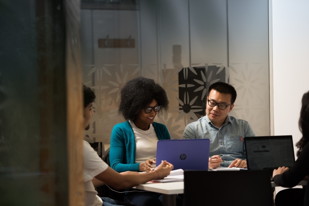 Postgraduate students using a study room in the Dearing building