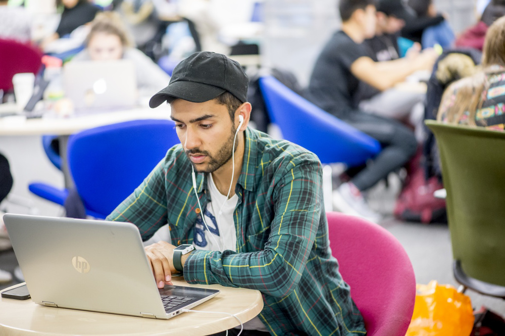 Student using a laptop in the library