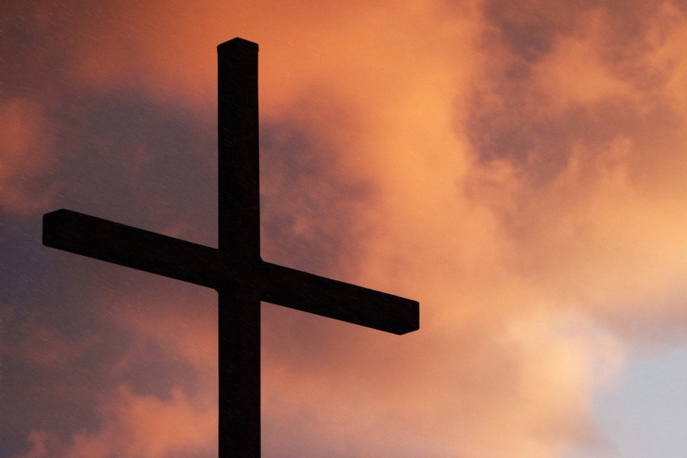 Sunset with silouette of a cross