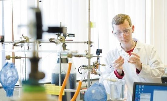 A chemistry student performs experiments in a lab