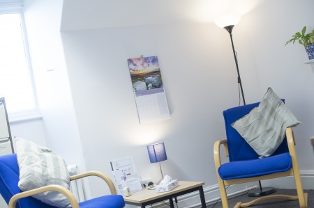 counselling room with two soft furnishing chairs and a table