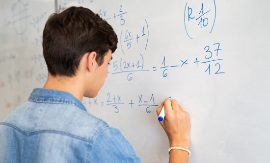 Boy drawing on whiteboard