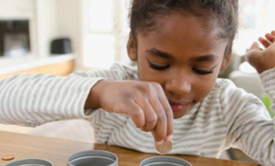 Child puts a penny in a pot