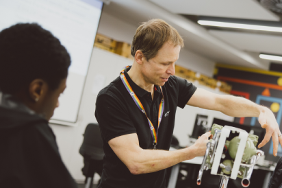 An assistant professor discussing the Rolls Royce engine with a student