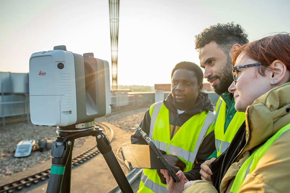 Students using a Total Station to capture their surroundings on the Geospatial Building roof