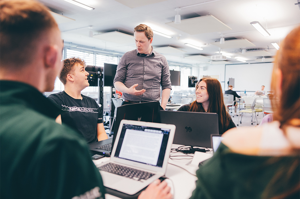 Undergraduate students and staff member in Engineering Science Learning Centre study spaces