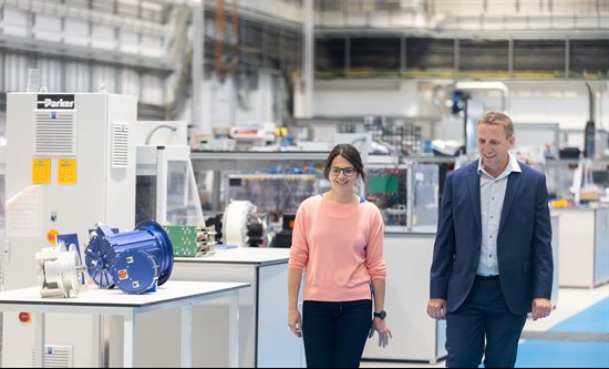 Dr Liliana de Lillo and Mark Gardiner walking through the Power Electronics and Machines Centre