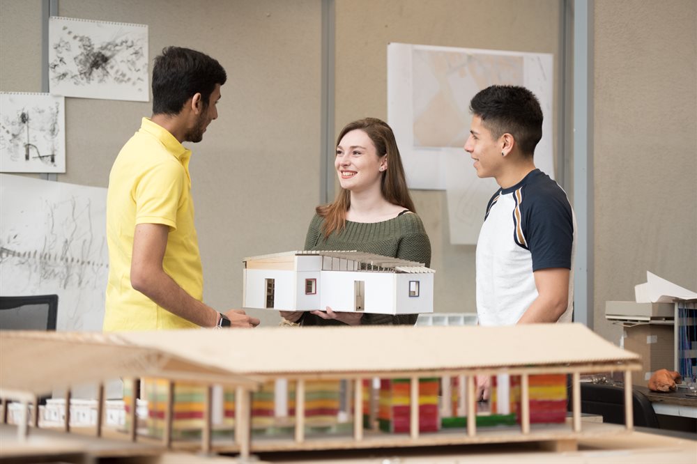 Three PhD students working in the architecture studio