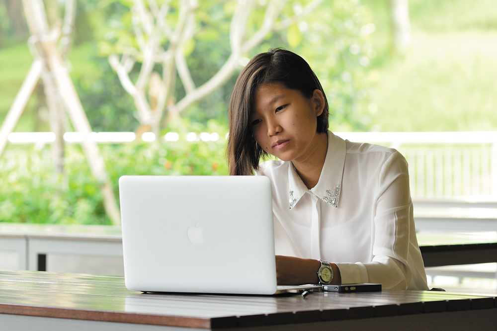 A distance learning student working on a laptop
