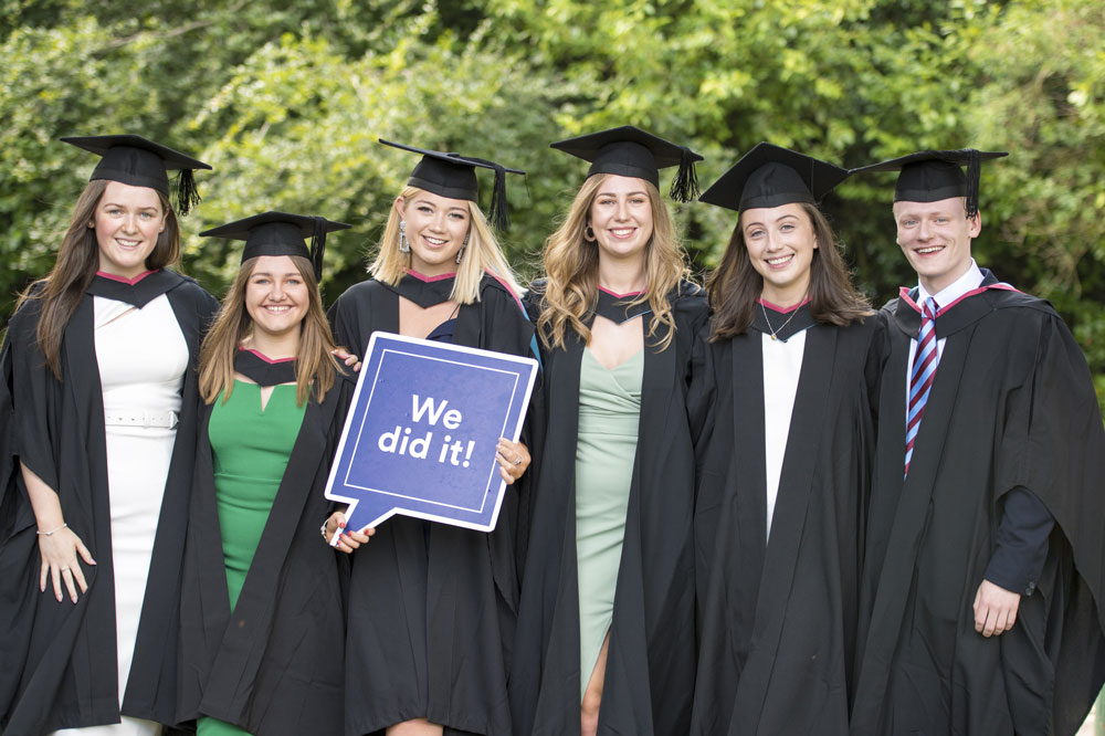 A group of six graduates on their graduation day