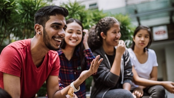 Diverse group of people sitting laughing