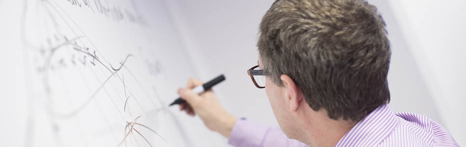 Maths professor writing on a whiteboard