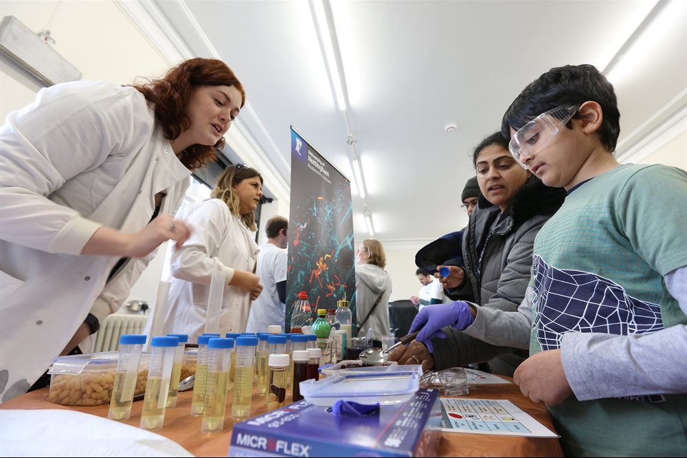 An exhibitor interacting with the public at Science in the Park