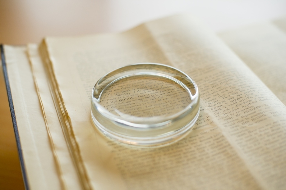 A magnifying glass on top of an open book
