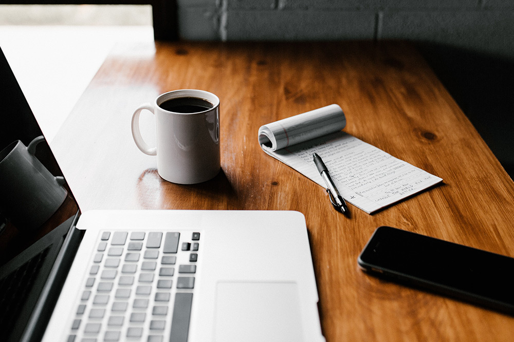 desk with laptop and coffee