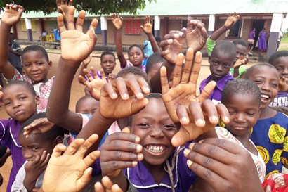 Schoolchildren reaching towards the camera