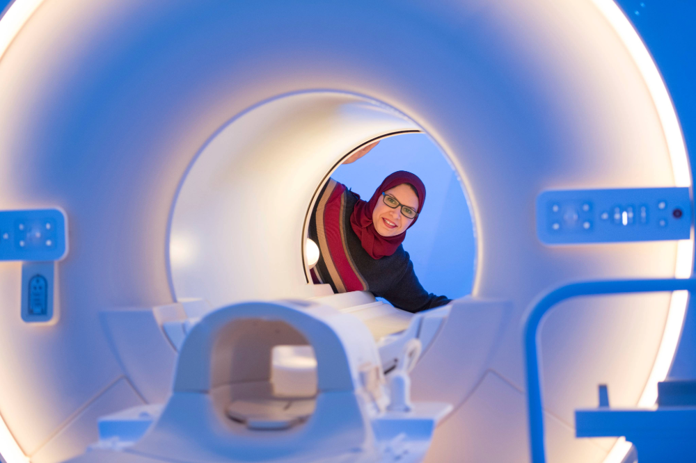Academic looking into the MRI scanner at the Sir Peter Mansfield Imaging Centre at University Park