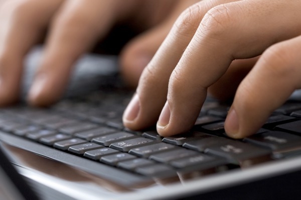Fingers on keyboard typing