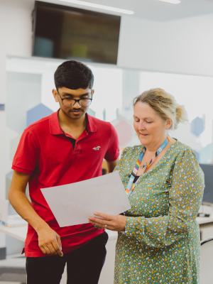 Student and member of staff looking at fees options